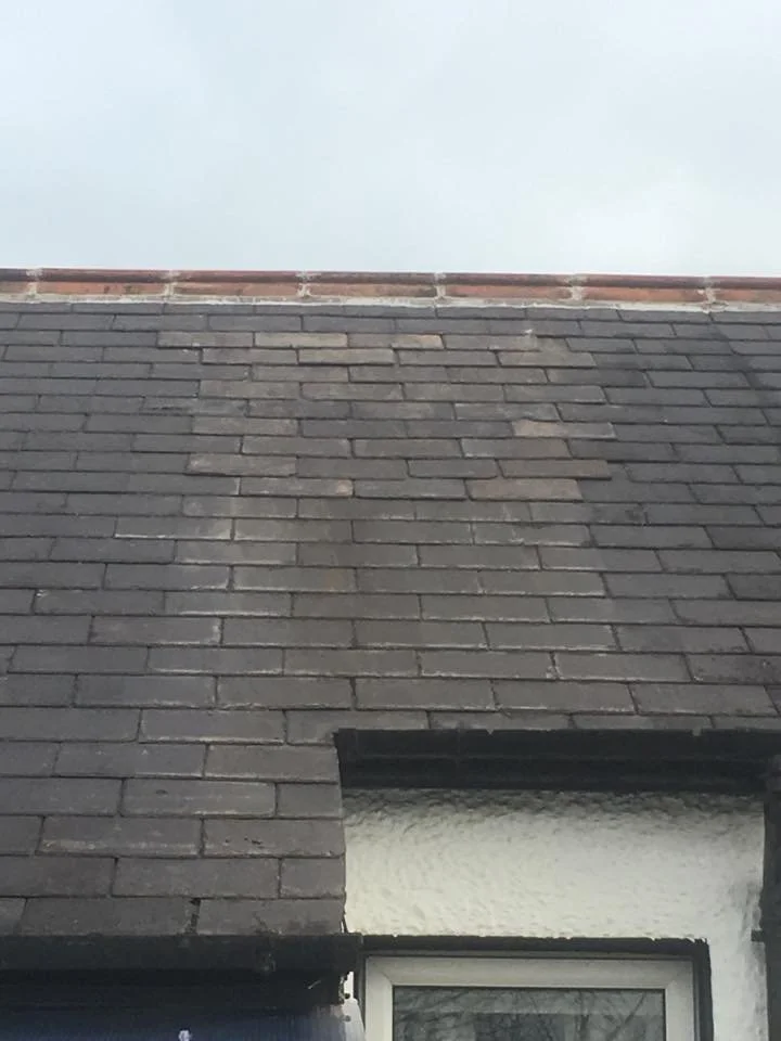 Before: worn slate roof above a rendered wall