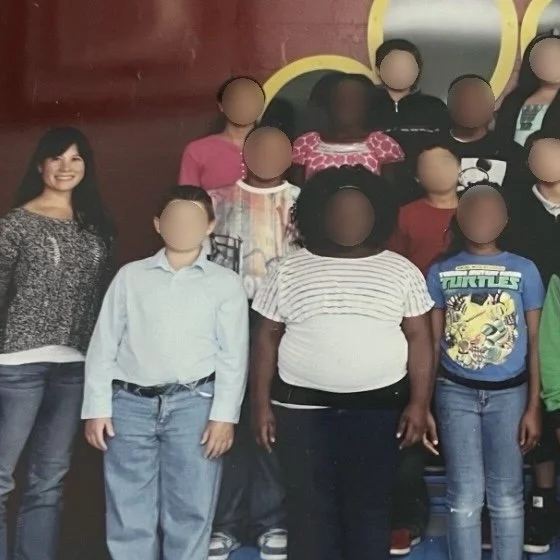 Ms. Lo's former 5th grade class: Group of children and teachers posing for a photo on a school team step with a colorful background and a red and yellow border.