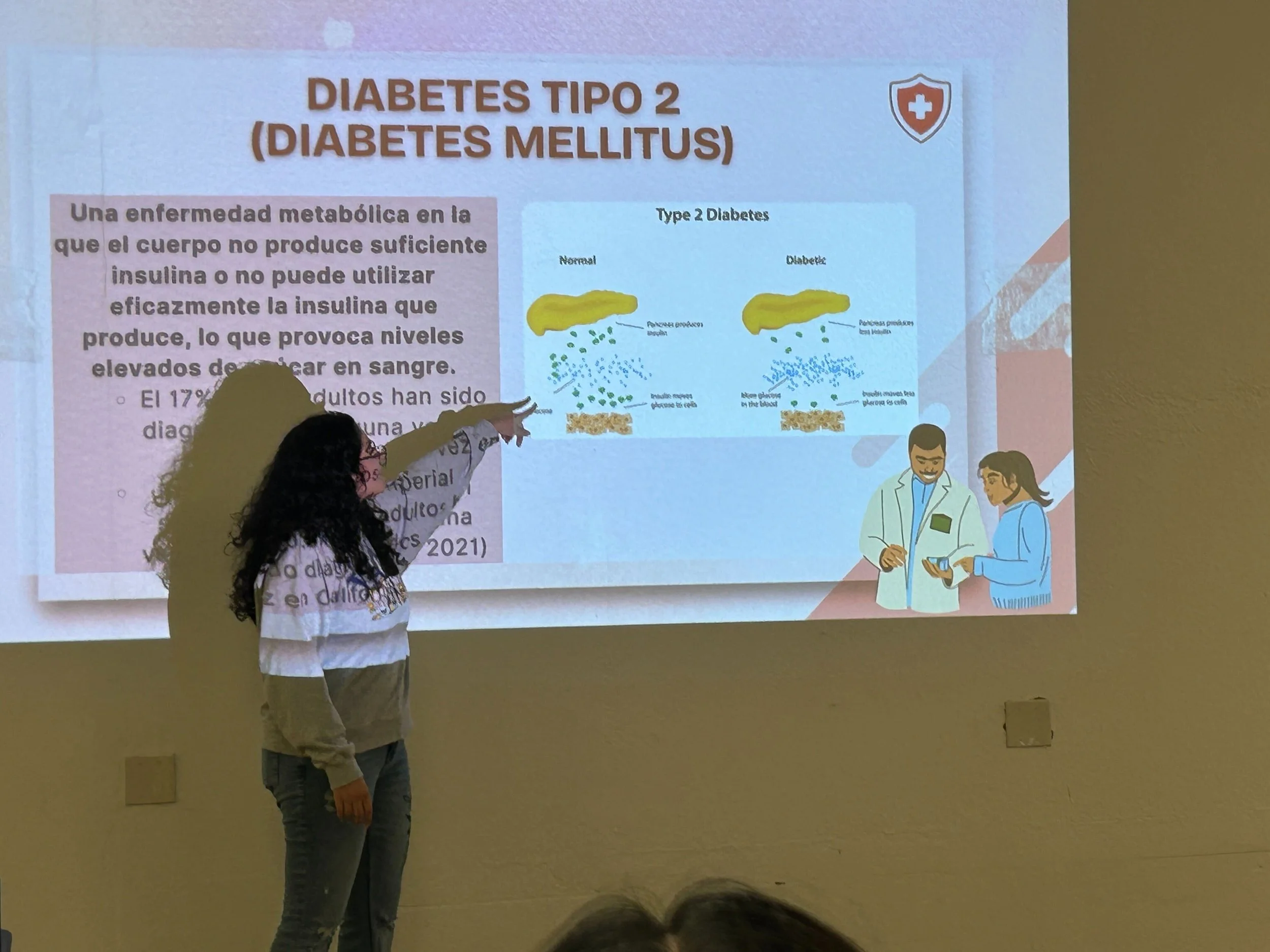 Yvette, an IV Equity intern, presents diabetes information to members of the community