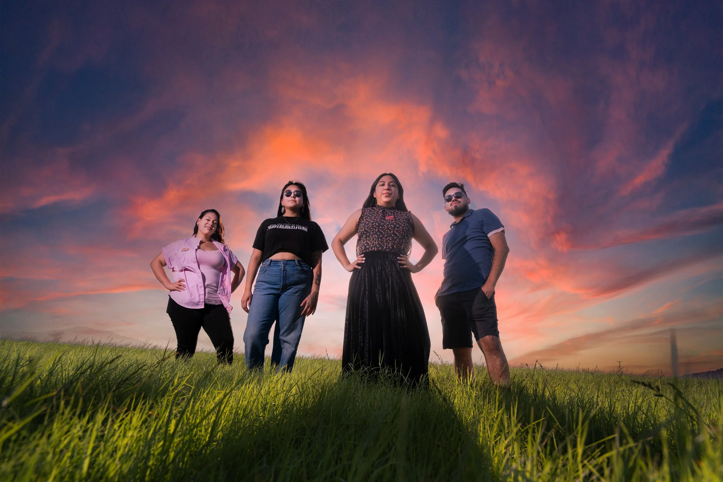 Members of the IV Equity team pose for an epic photo in front of a sunset taken by Bryan Patrick