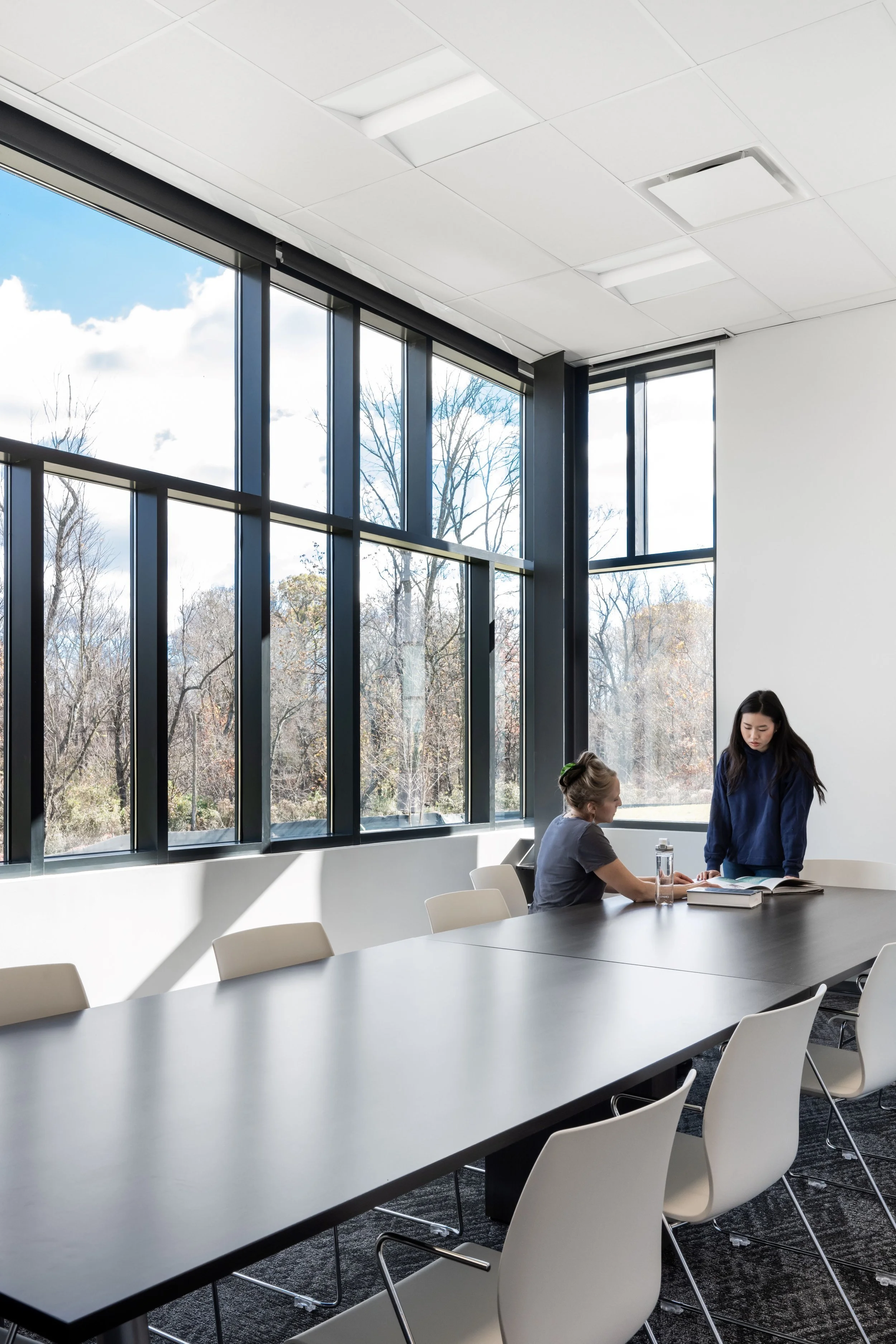 27-zaffere-library-students-at-a-long-table-by-a-corner-window.jpg