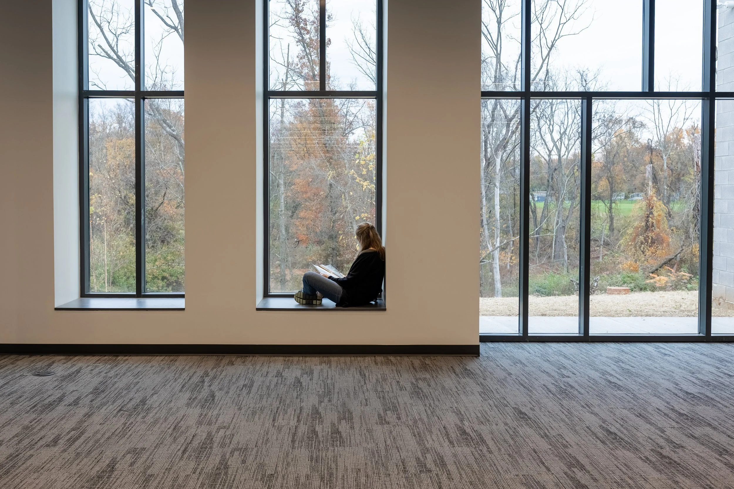 25-zaffere-library-a-student-reading-on-a-deep-window-sill.jpg