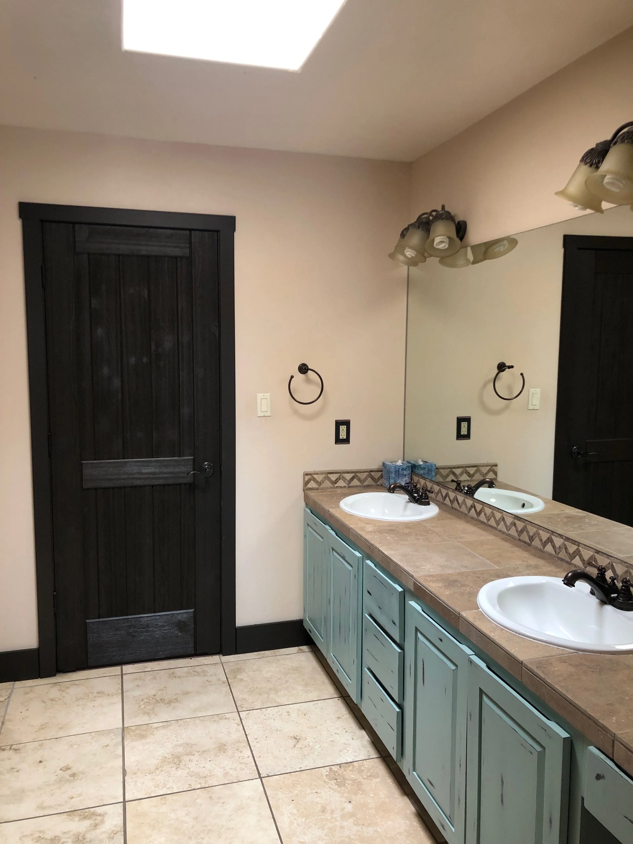 Guest bath new trim, painted doors, and distressed style paint on the cabinets.