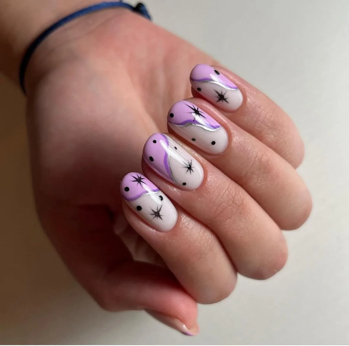 High-detail custom nail art design with layered color work and intricate hand-painted accents.