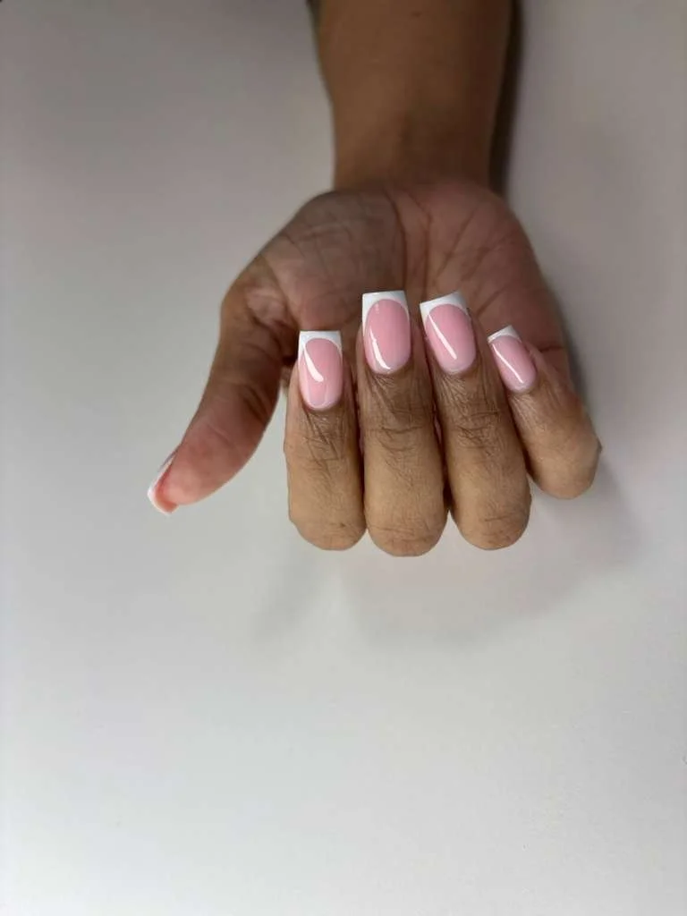 Classic French tip manicure with clean white edges and balanced nail structure.
