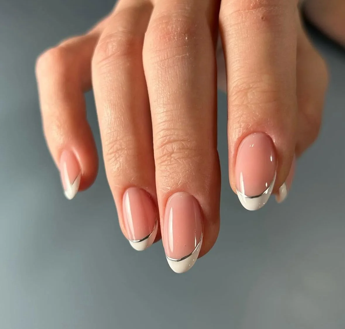 Double French tip manicure featuring precise dual-line detailing and refined structure.