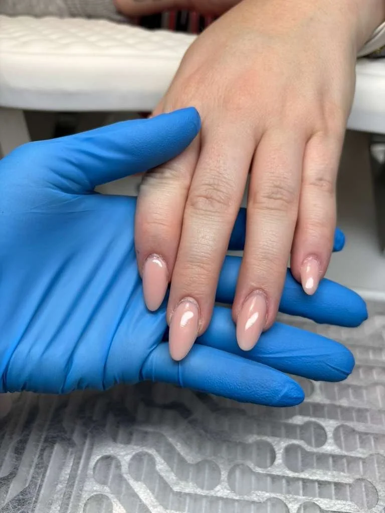 Shape refinement and cuticle recovery during structured hard gel Russian manicure showing improved nail growth and stability in Richmond Virginia