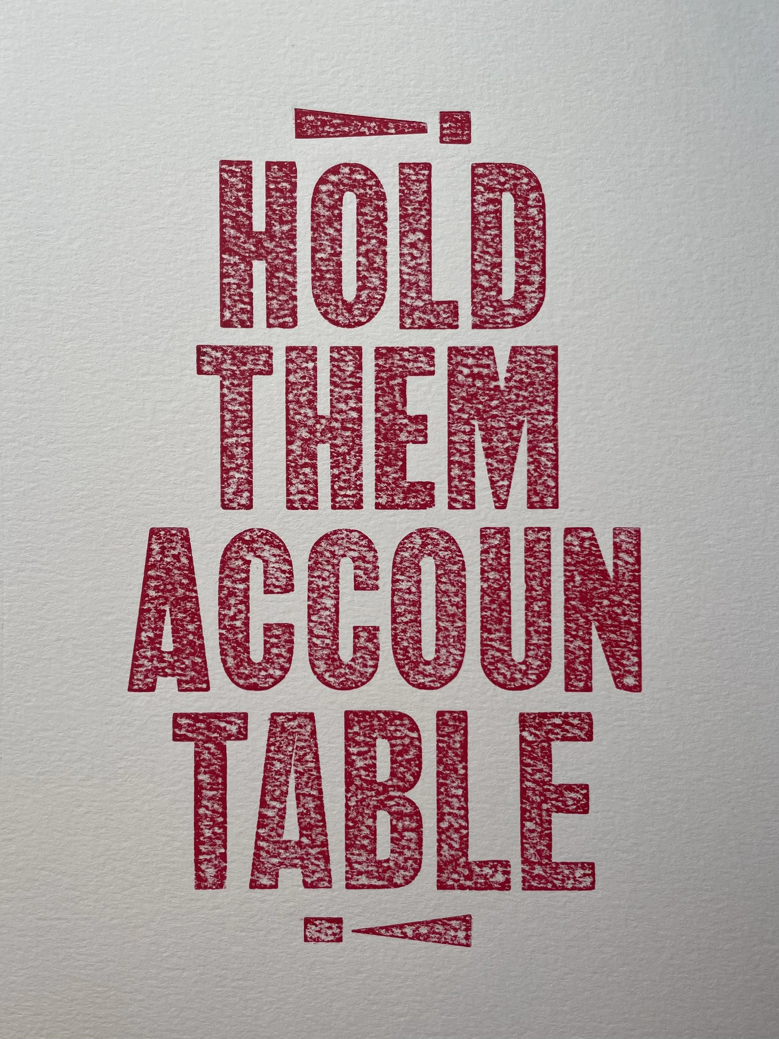 Letterpress print reading 'Hold them a cucumber table' in red on textured paper.