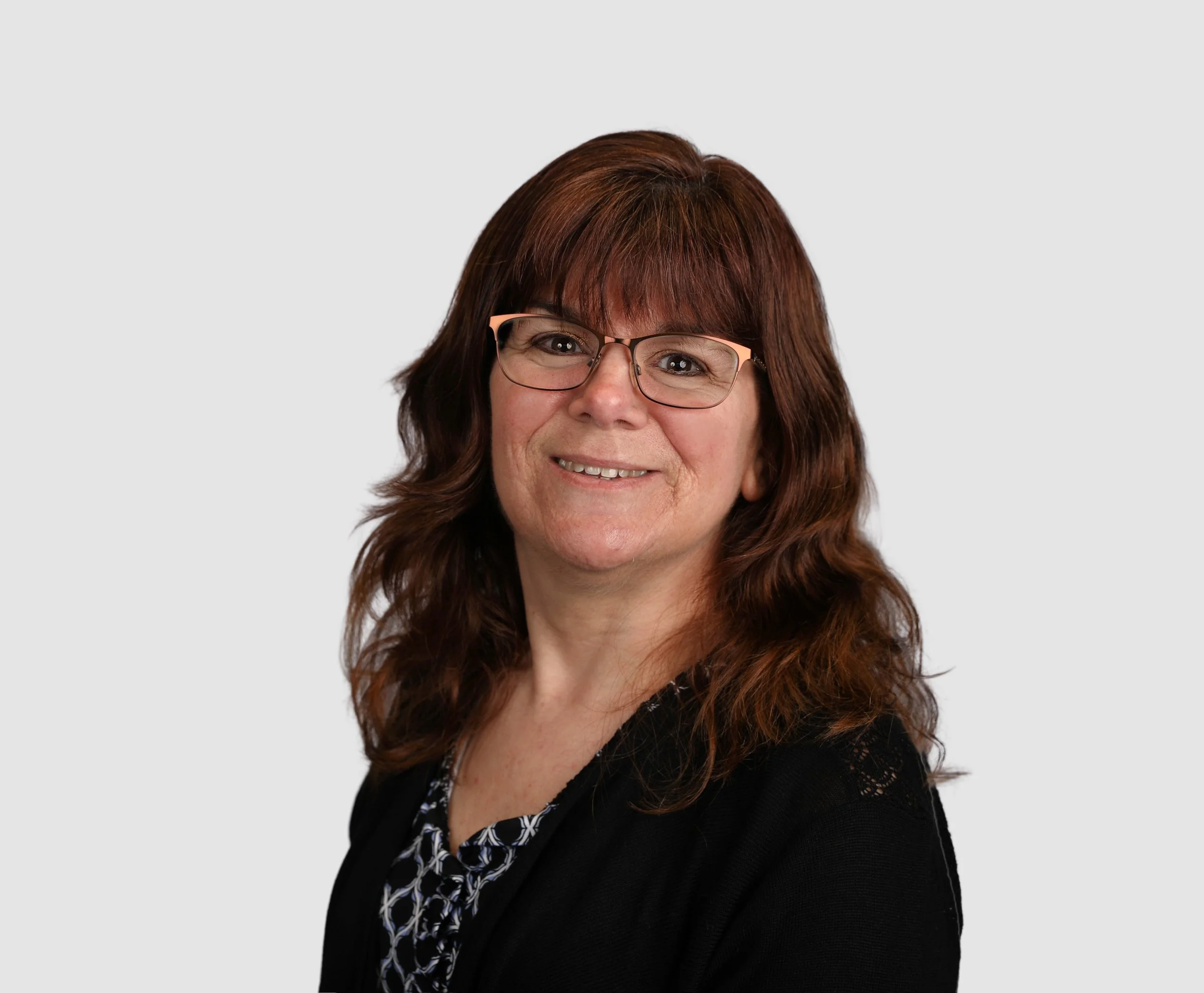 A woman with glasses and long brown hair