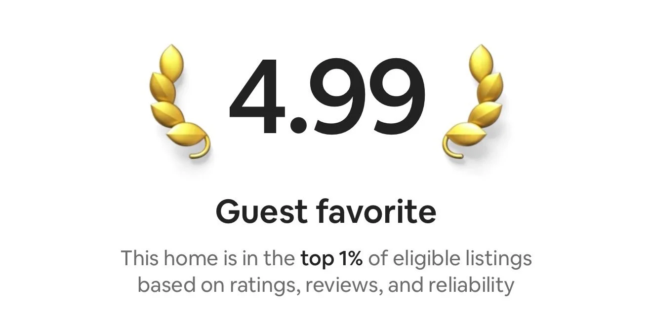 A review score of 4.99 with gold leaves on either side, labeled 'Guest favorite,' indicating the home is in the top 1% of eligible listings based on ratings, reviews, and reliability.