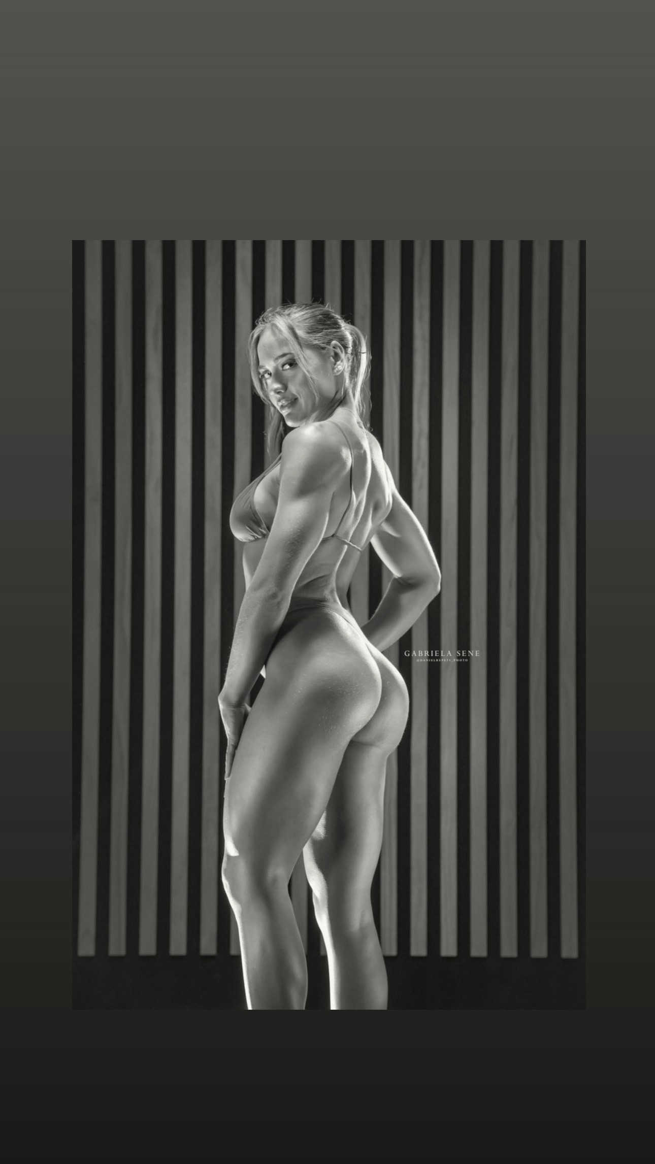 FEMALE BODYBUILDER ON STAGE DOING A POSE