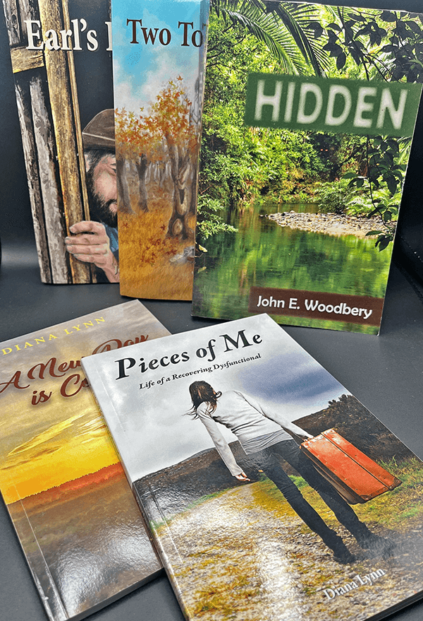 Five books on a tabletop. Each one has a nature image on the cover along with titles in different fonts.