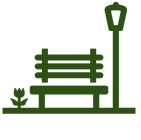 A park with a bench, a streetlamp, and some grass.