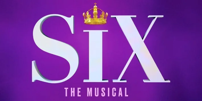 Logo for 'Six: The Musical' with purple background, large white letters spelling 'SIX', a gold crown above the 'I', and the subtitle 'The Musical' at the bottom.