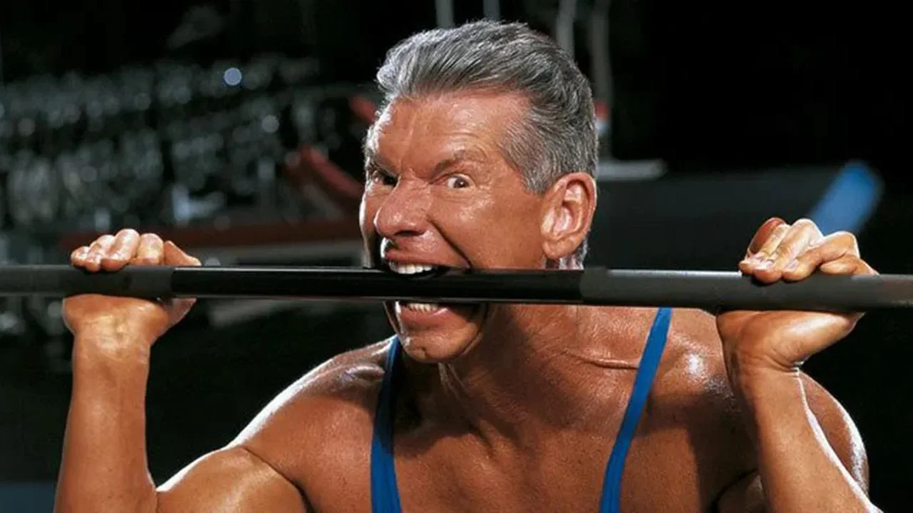 Vince-McMahon-Biting-Dumbell-1280x720.webp