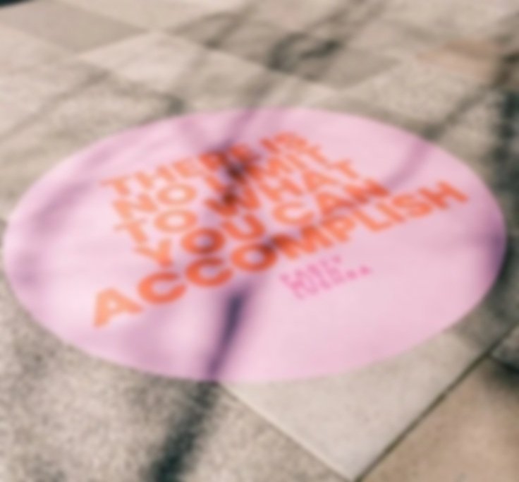 Branded sidewalk decal installed on city pavement for street-level marketing