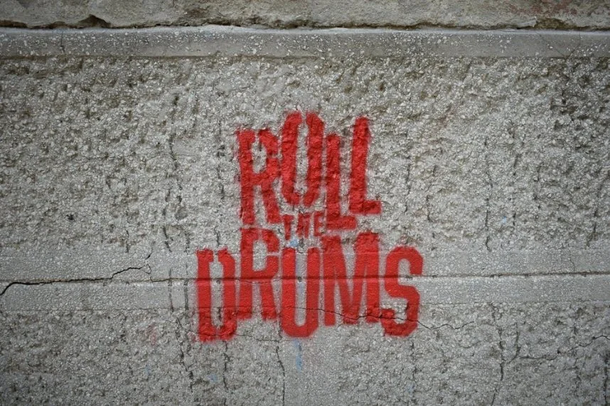 Sidewalk stencil advertising applied to a concrete pedestrian walkway