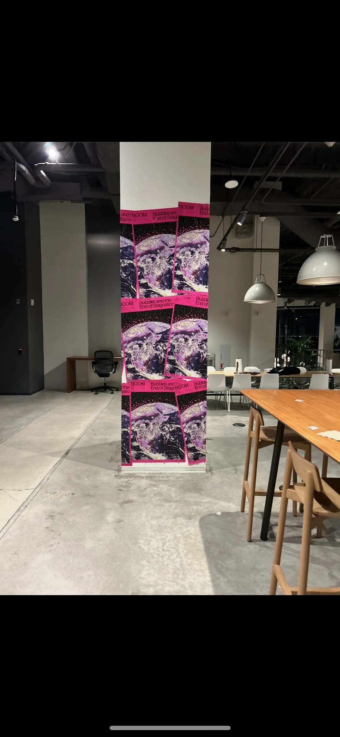 Custom indoor poster installation using creative wheatpasting techniques on interior walls