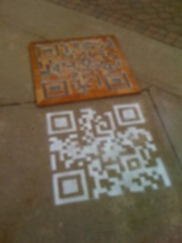 Sidewalk stencil advertising placed along a high-foot-traffic pedestrian walkway
