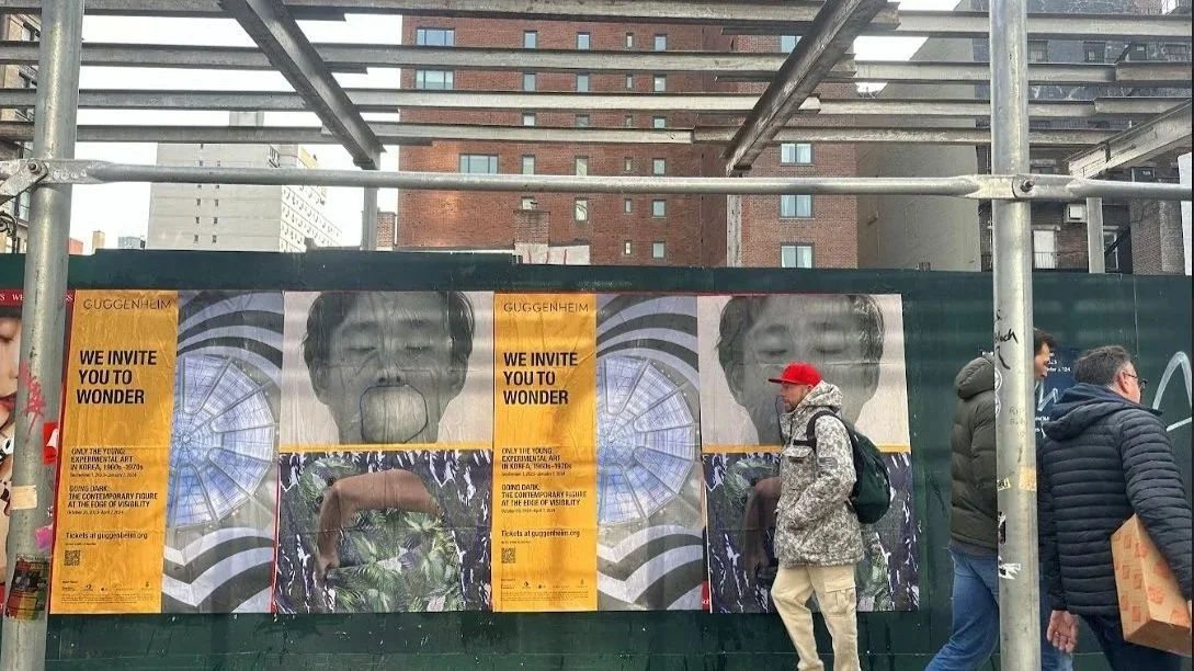 Street-level wheatpaste poster advertising on city walls