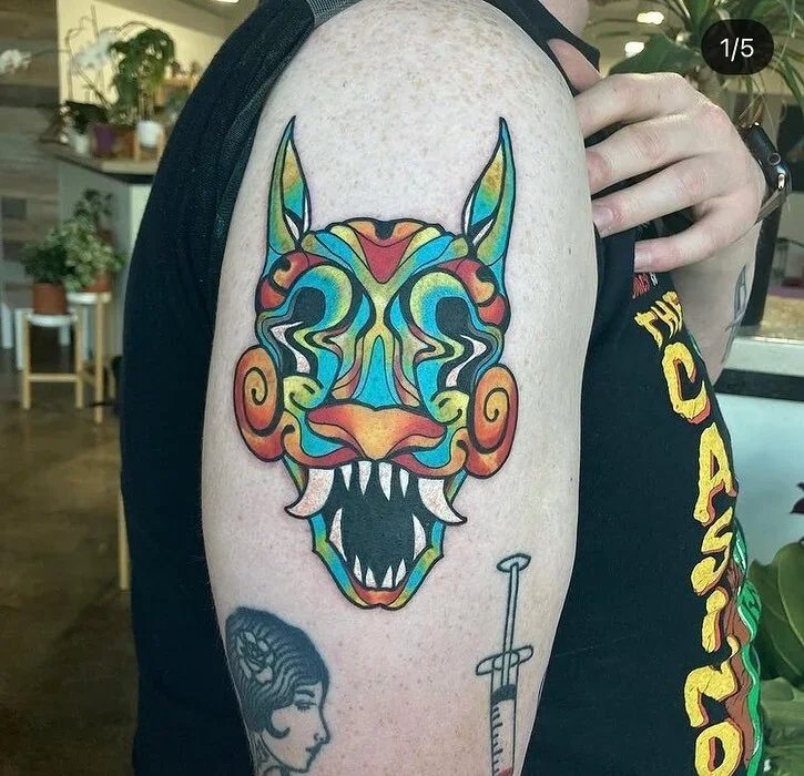 tattoo by Ella Baer - surrealist mask on arm