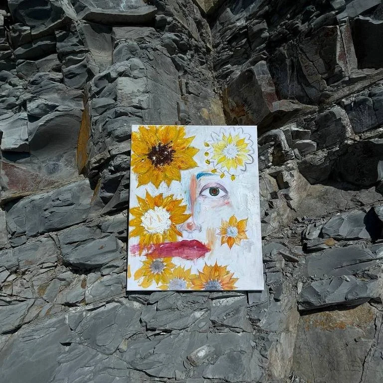Abstract painting sitting on a rock