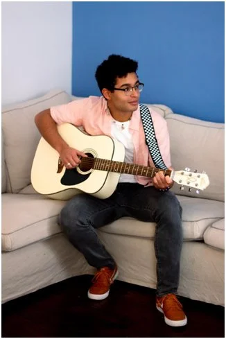 Song Writer Tyell-Gustavson with Guitar