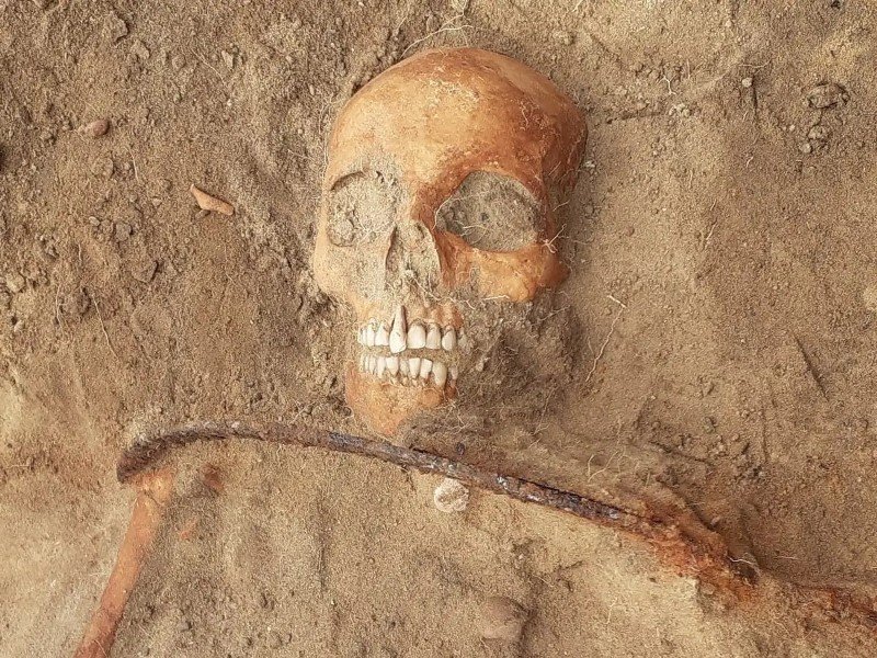 Vampire grave with a sickle across the neck