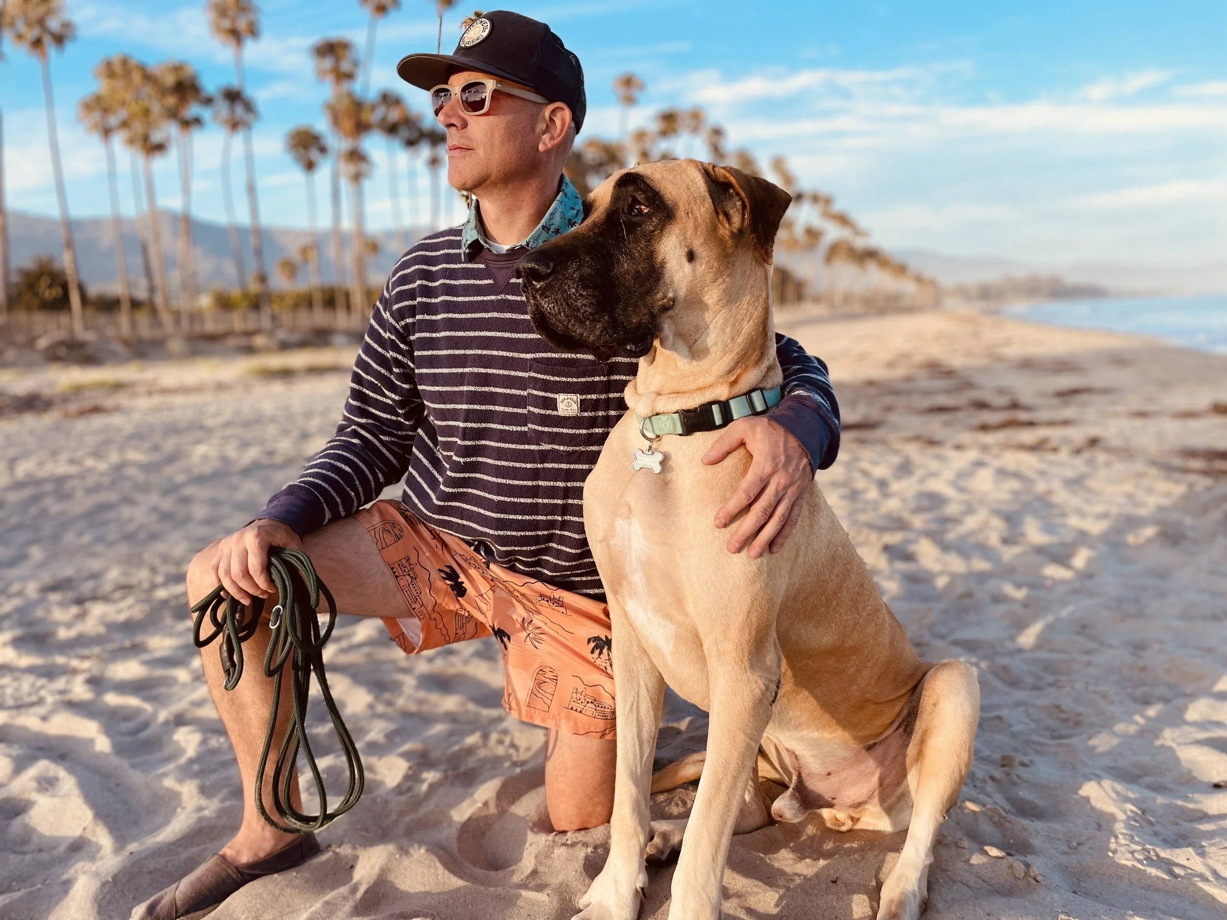 The author, Chris Wax on the beach with his giant dog.