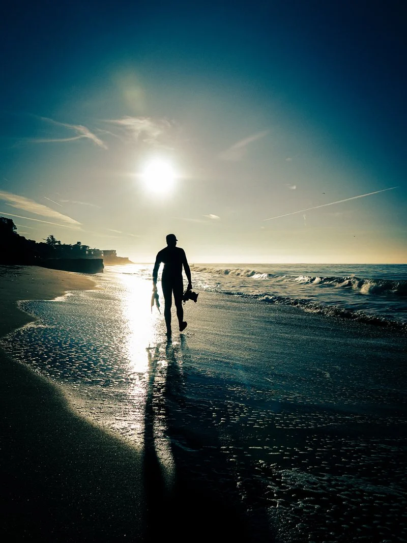 surf photographer Michael Allen walking on beach