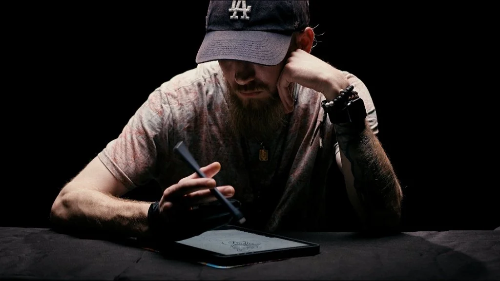 Bryant Howerton - Tattoo Artist working on tablet