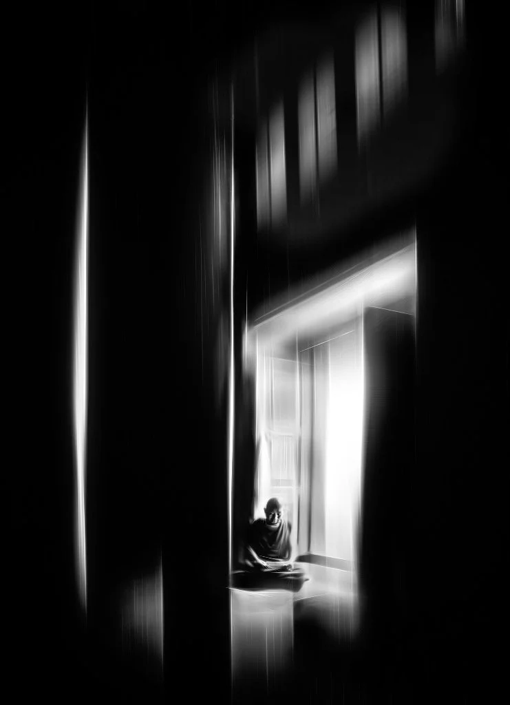 black and white photo of monk in prayer