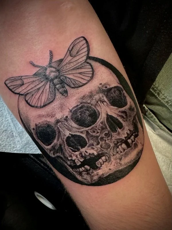 black and gray moth with skulls tattoo - by Vic Tamian