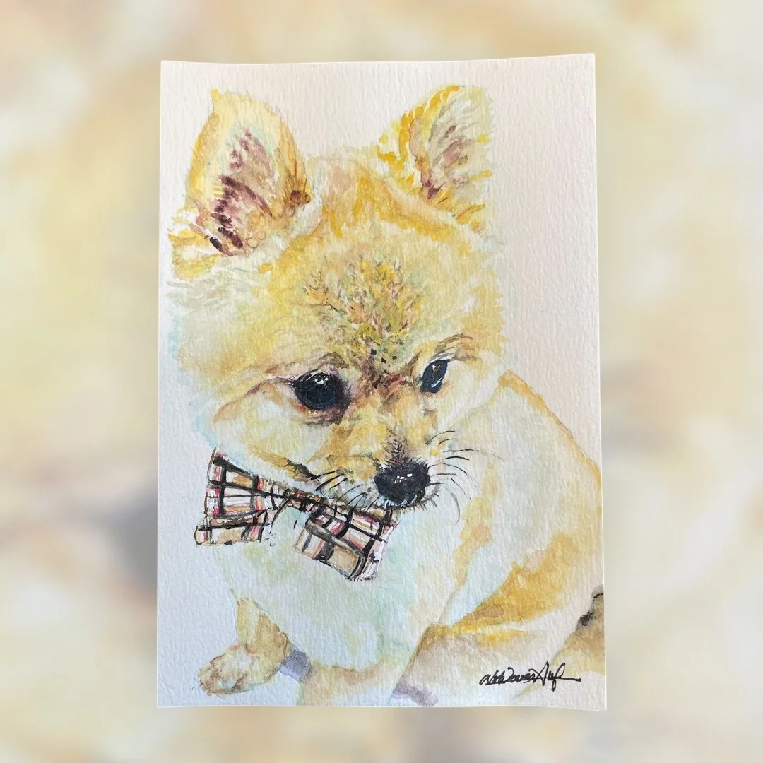 水彩画の子犬の絵で、首にチェック柄のリボンをつけている