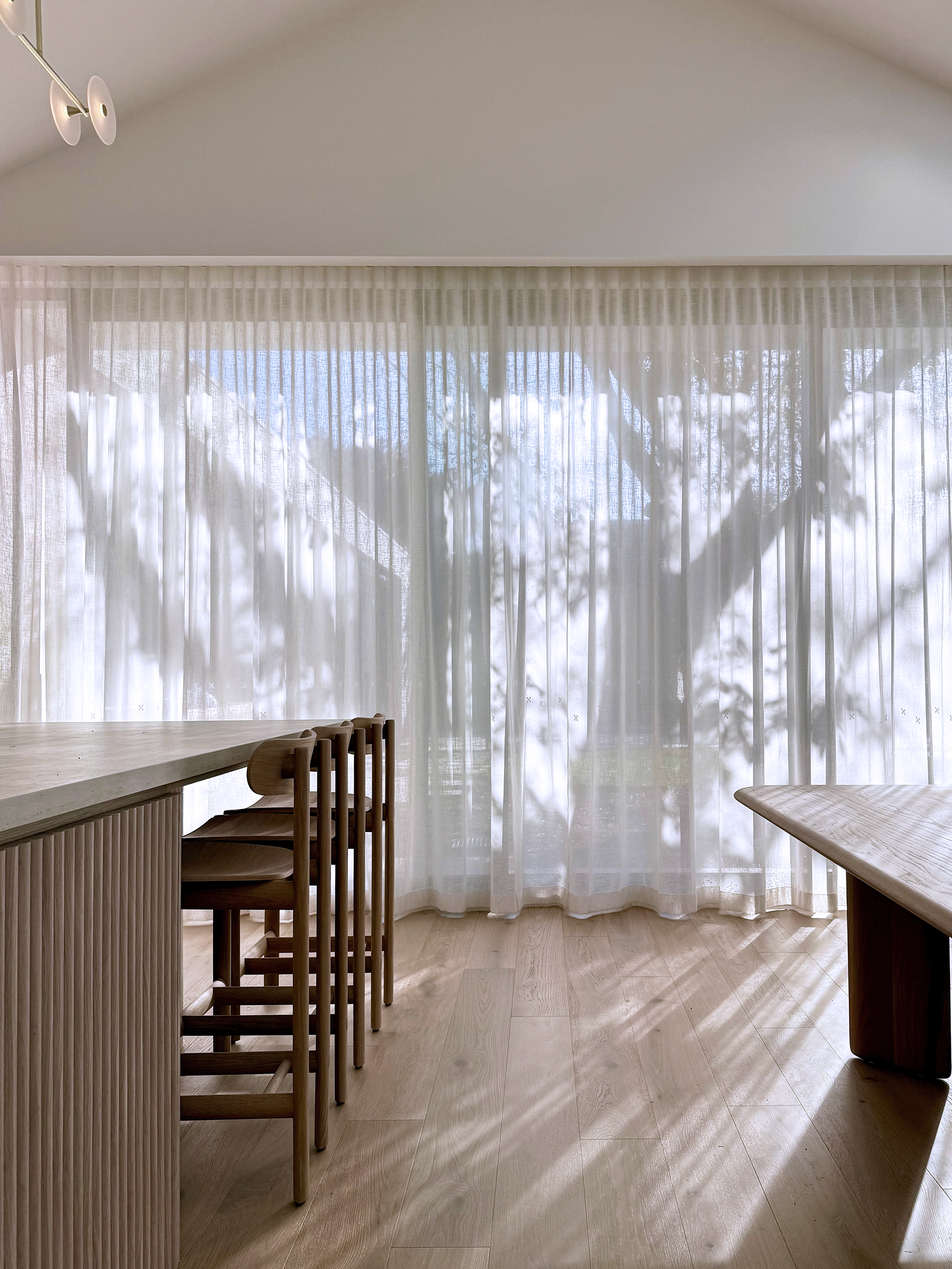 Minimalist dining room with shadows and curtains