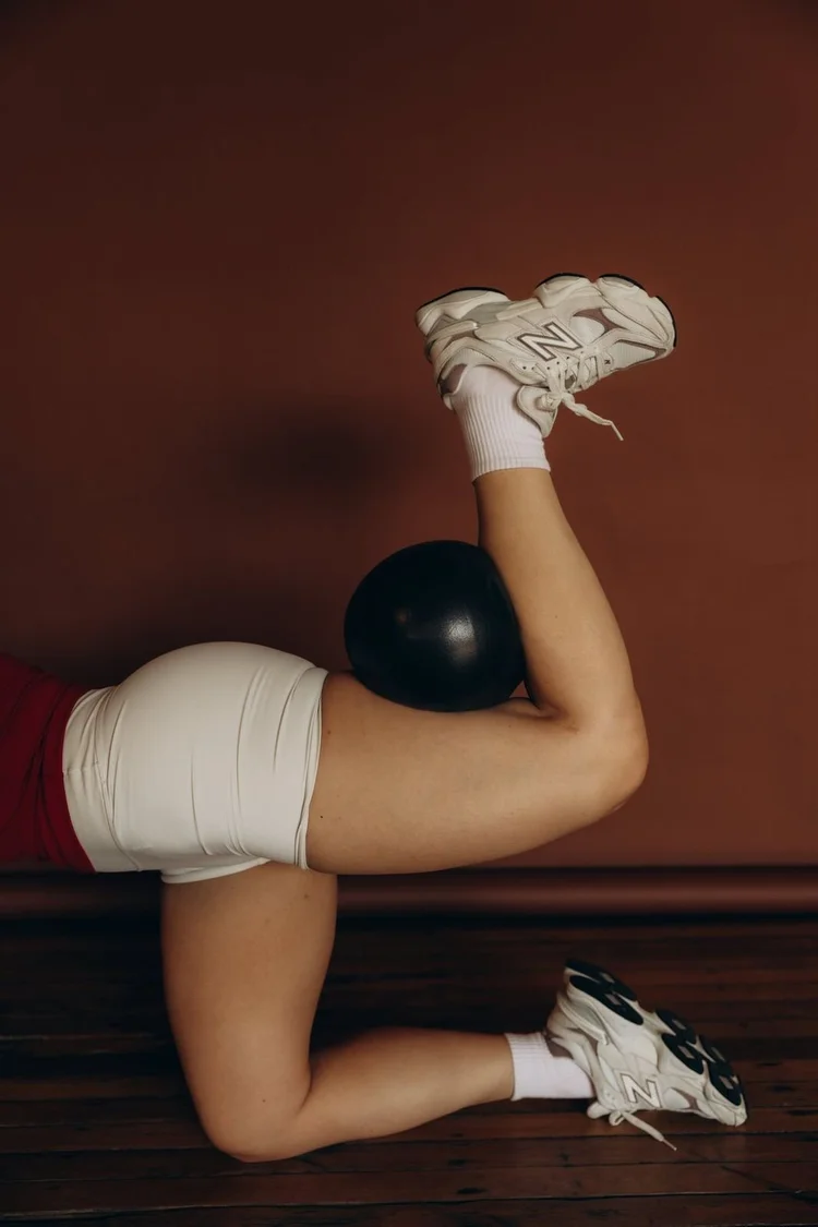 A kneeling leg lift with a ball