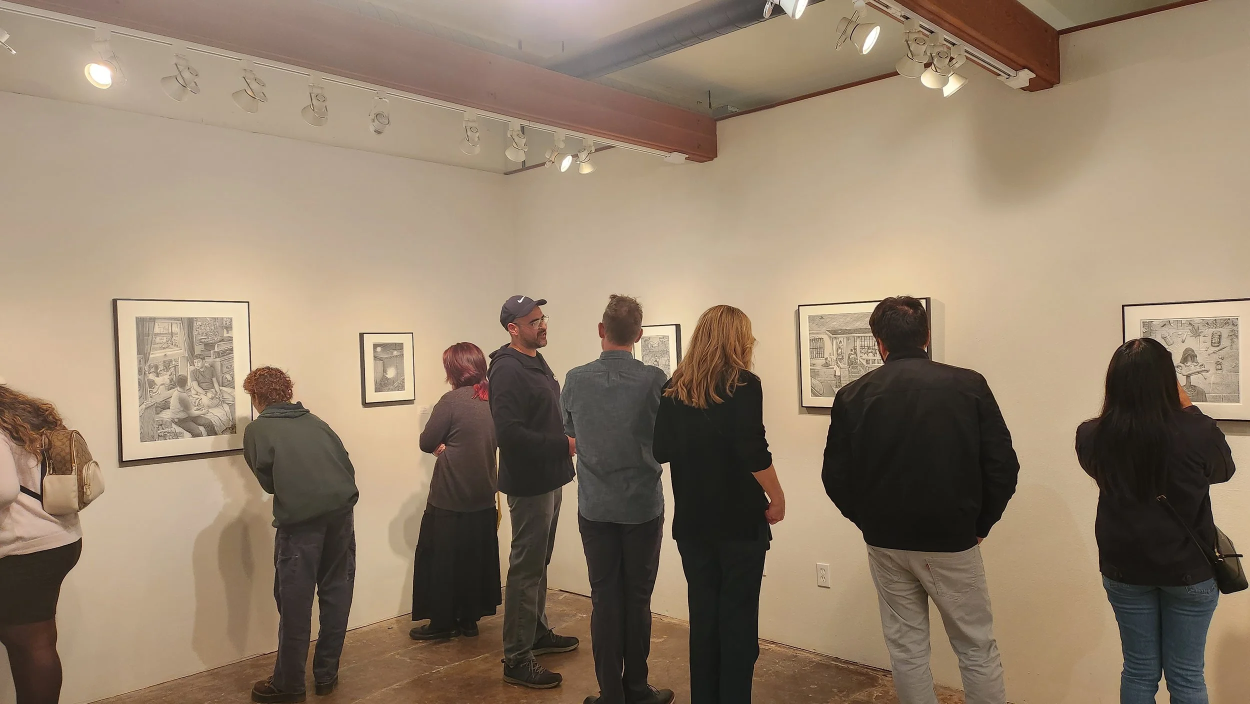 People viewing the artwork of Horacio Martinez during an art show at VITA art gallery.
