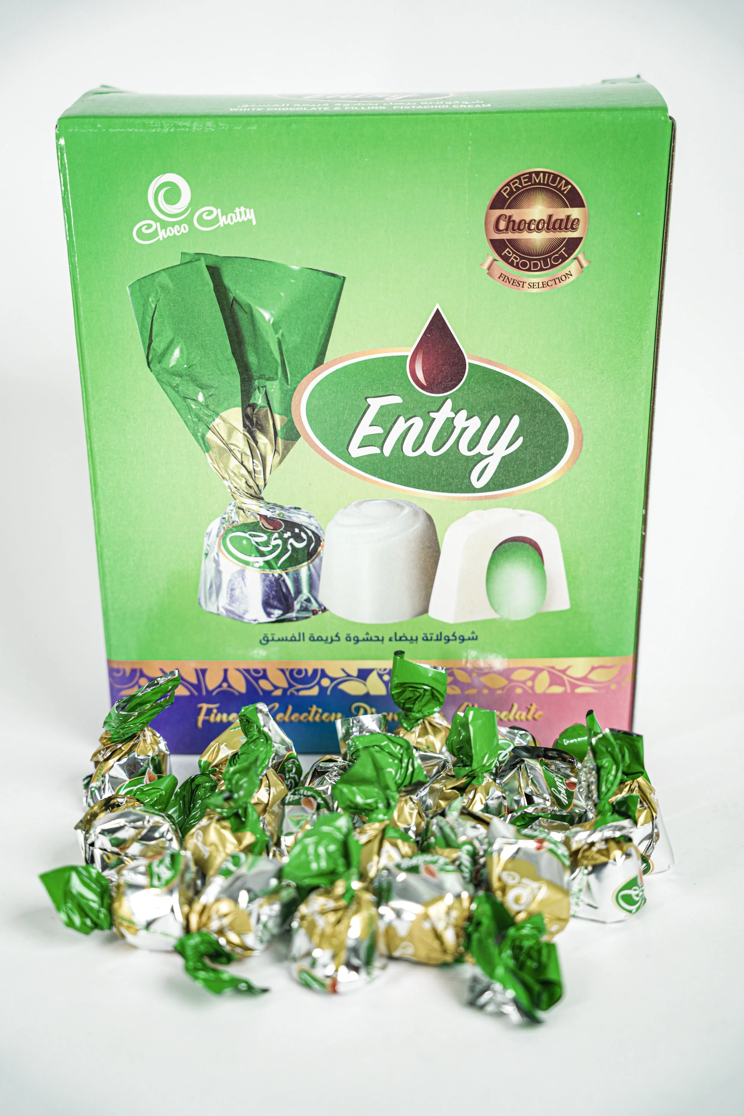 A box of Choco Chatty Entry chocolates with individual wrapped candies in green and gold foil in front of the box.