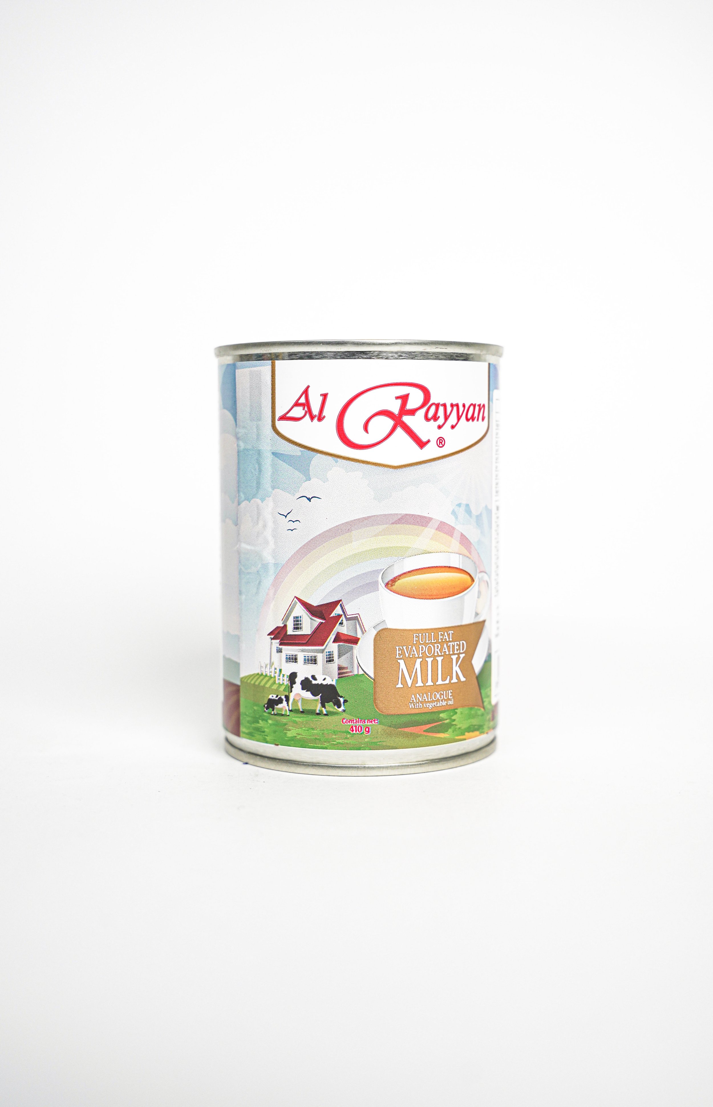 Canned evaporated full-fat milk in a colorful label with a house and cows on green grass, featuring the brand name 'Al Rayyan'.