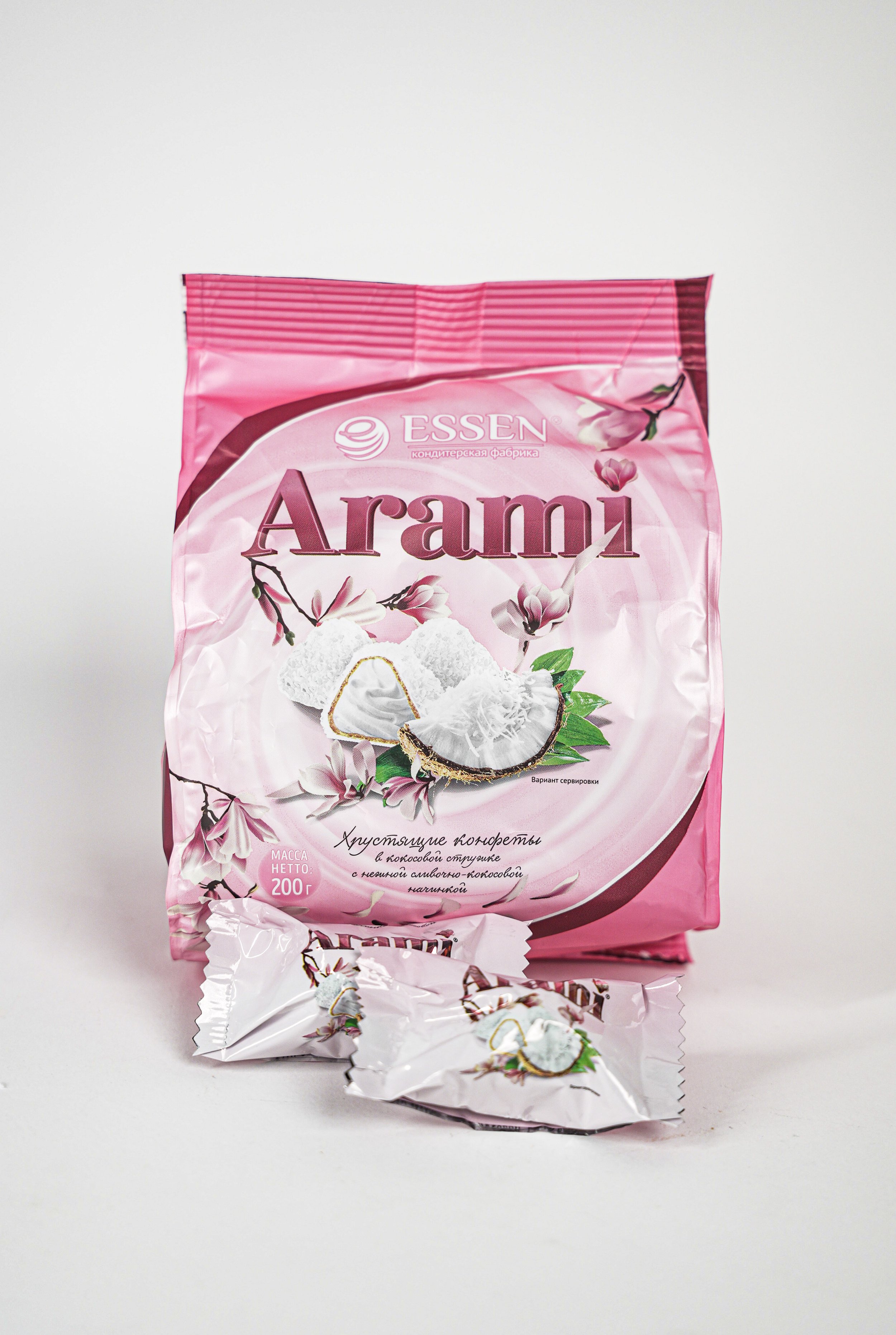 Pink package of Arami coconut candies with illustrations of coconut and flowers, and two wrapped candies in front.