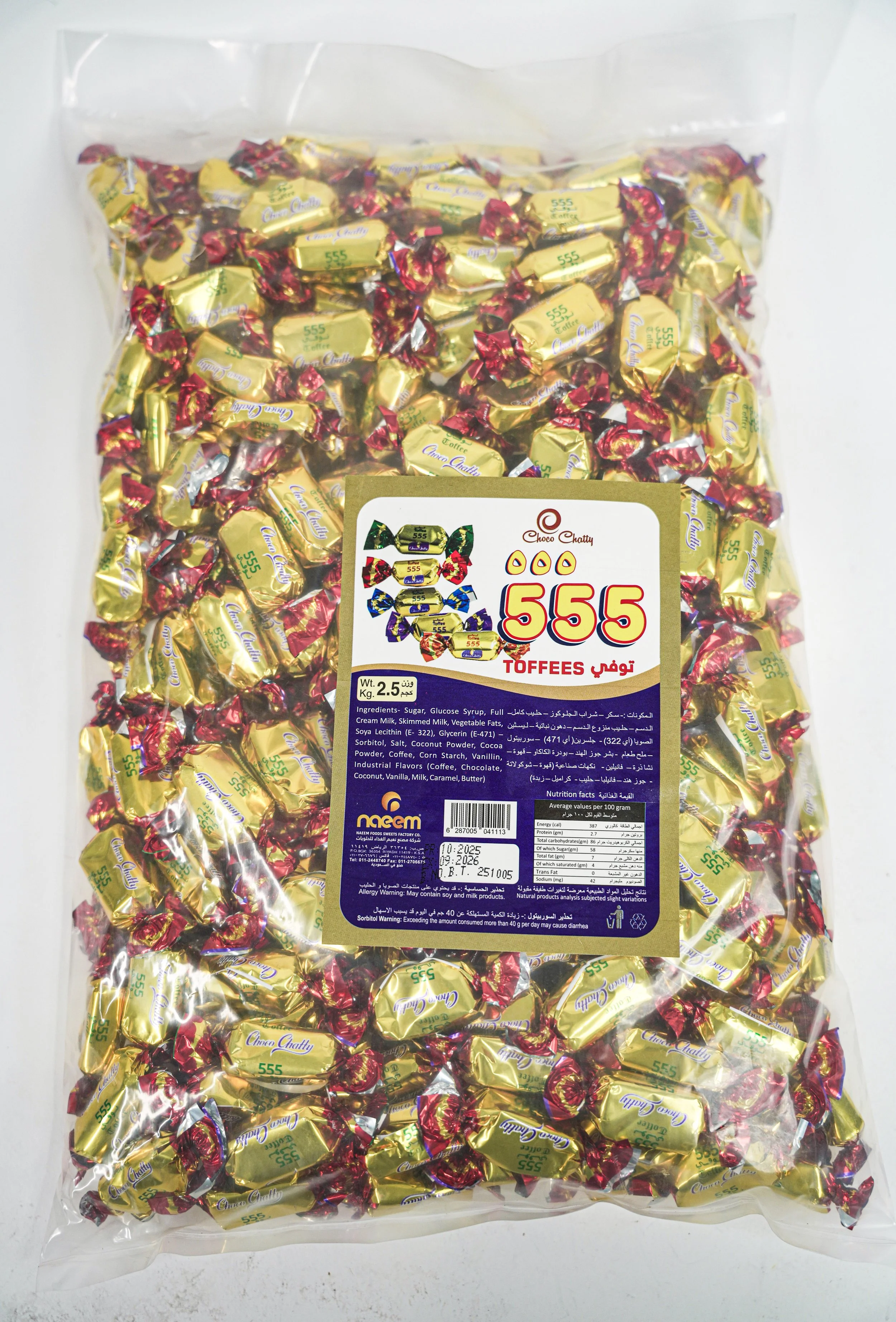 A plastic bag filled with individually wrapped toffee candies labeled '555'. The wrapper is gold with red, green, blue, and purple accents. The label on the bag shows the product name, weight, ingredients, nutrition facts, and barcode.