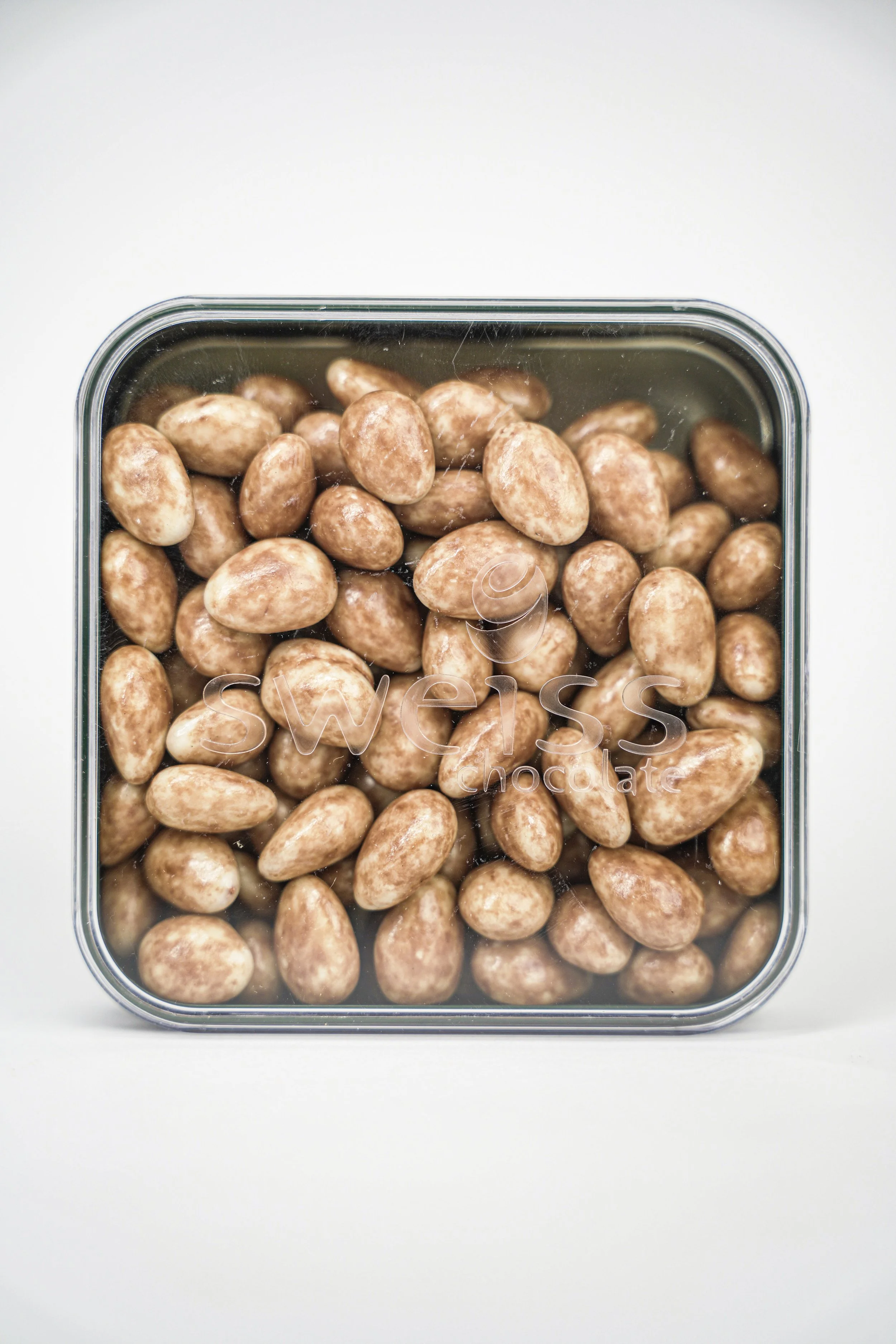 A clear container filled with coated chocolate almonds labeled 'Sweet Swiss' on the lid.