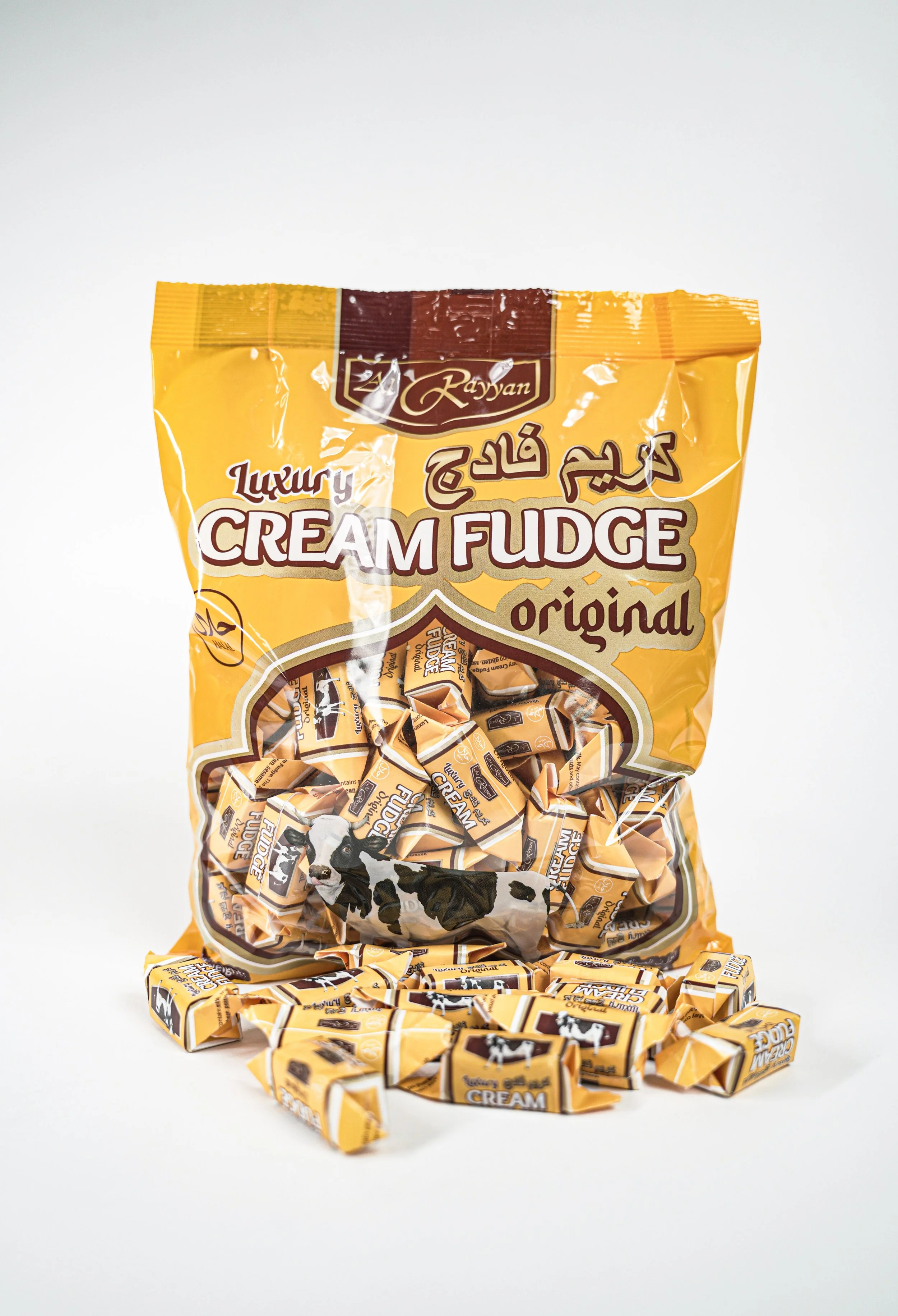 Al Rayyan Cream fudge candies, cow illustration and yellow packaging.