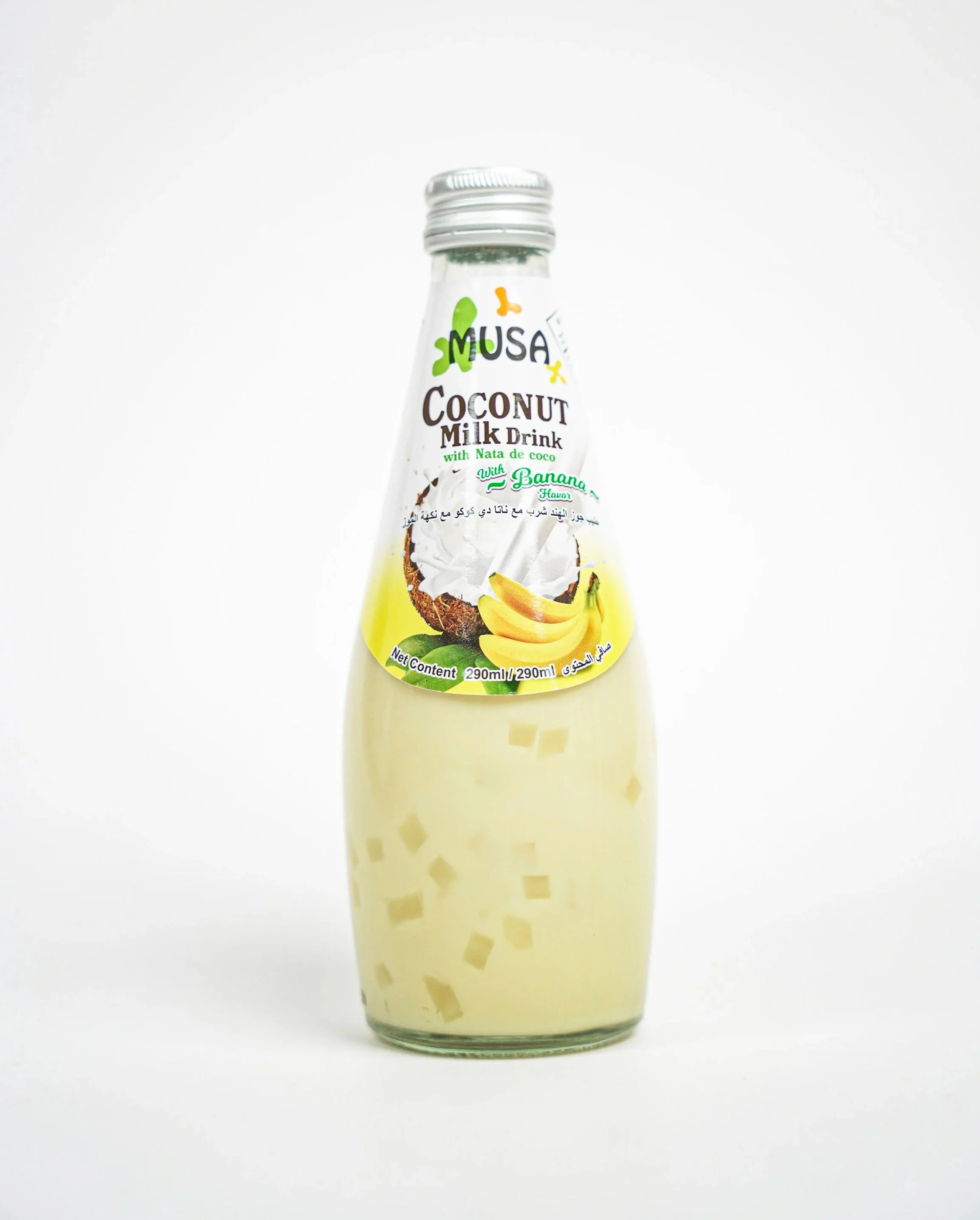 A clear glass bottle of MUSA coconut milk drink with banana flavor, featuring a label with images of a coconut and bananas