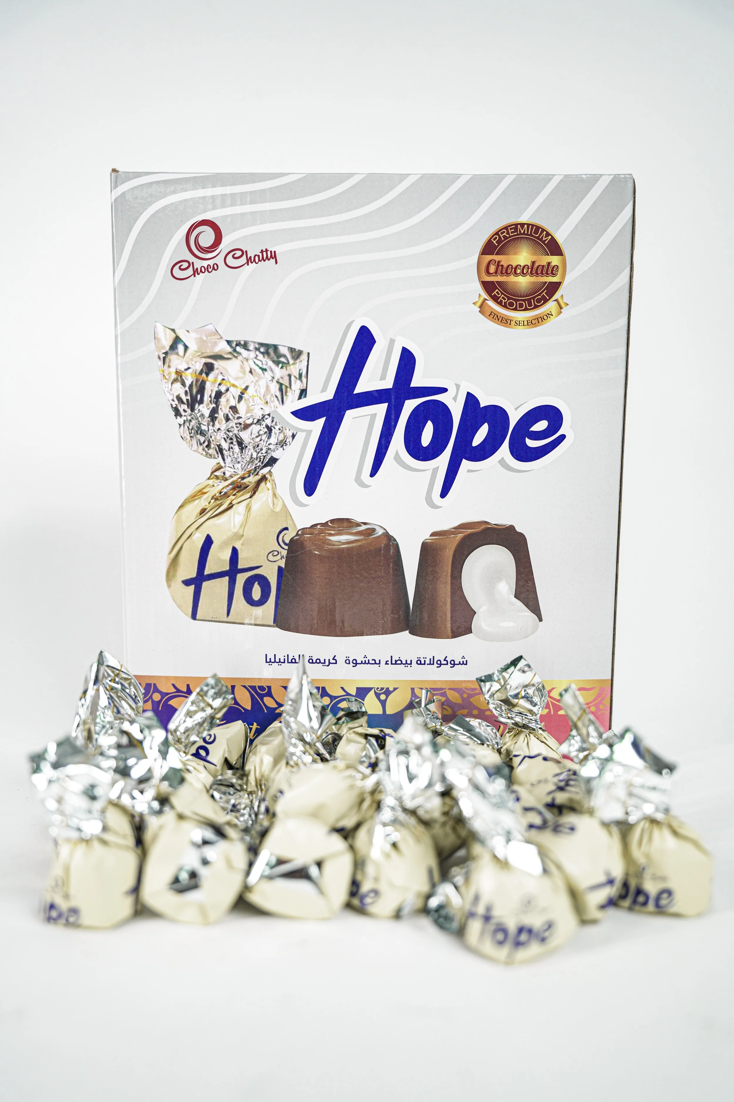 A box of Hope chocolate candies with several wrapped candies in front of it on a white background.