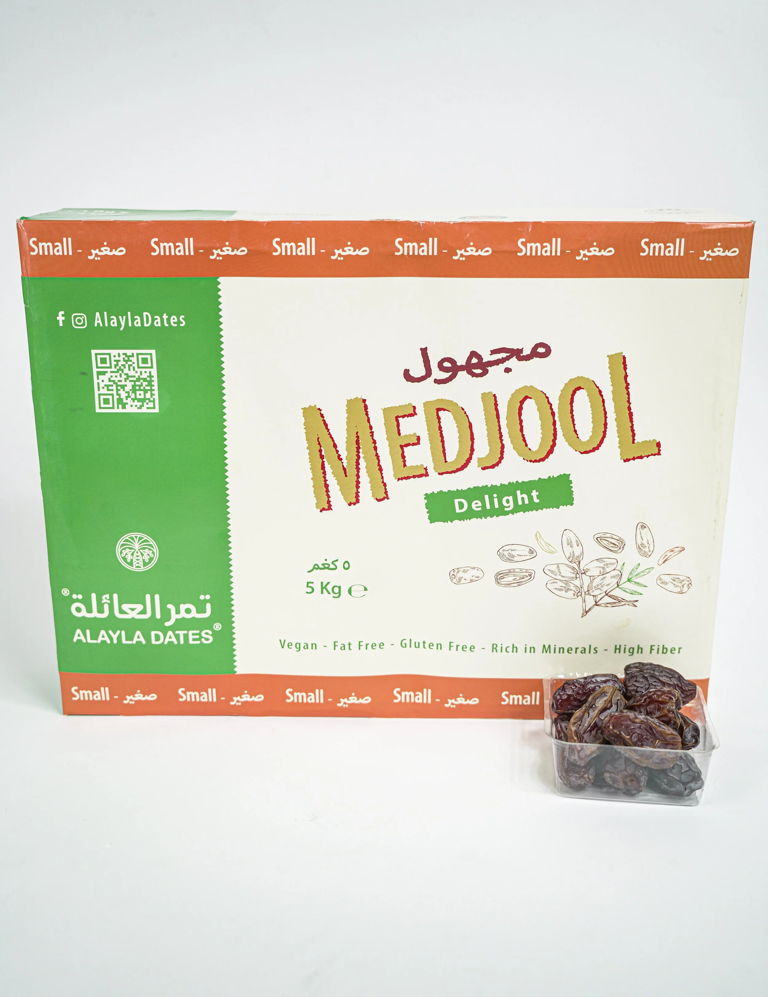 A box of Medjool dates with a small container of dates in front of it.