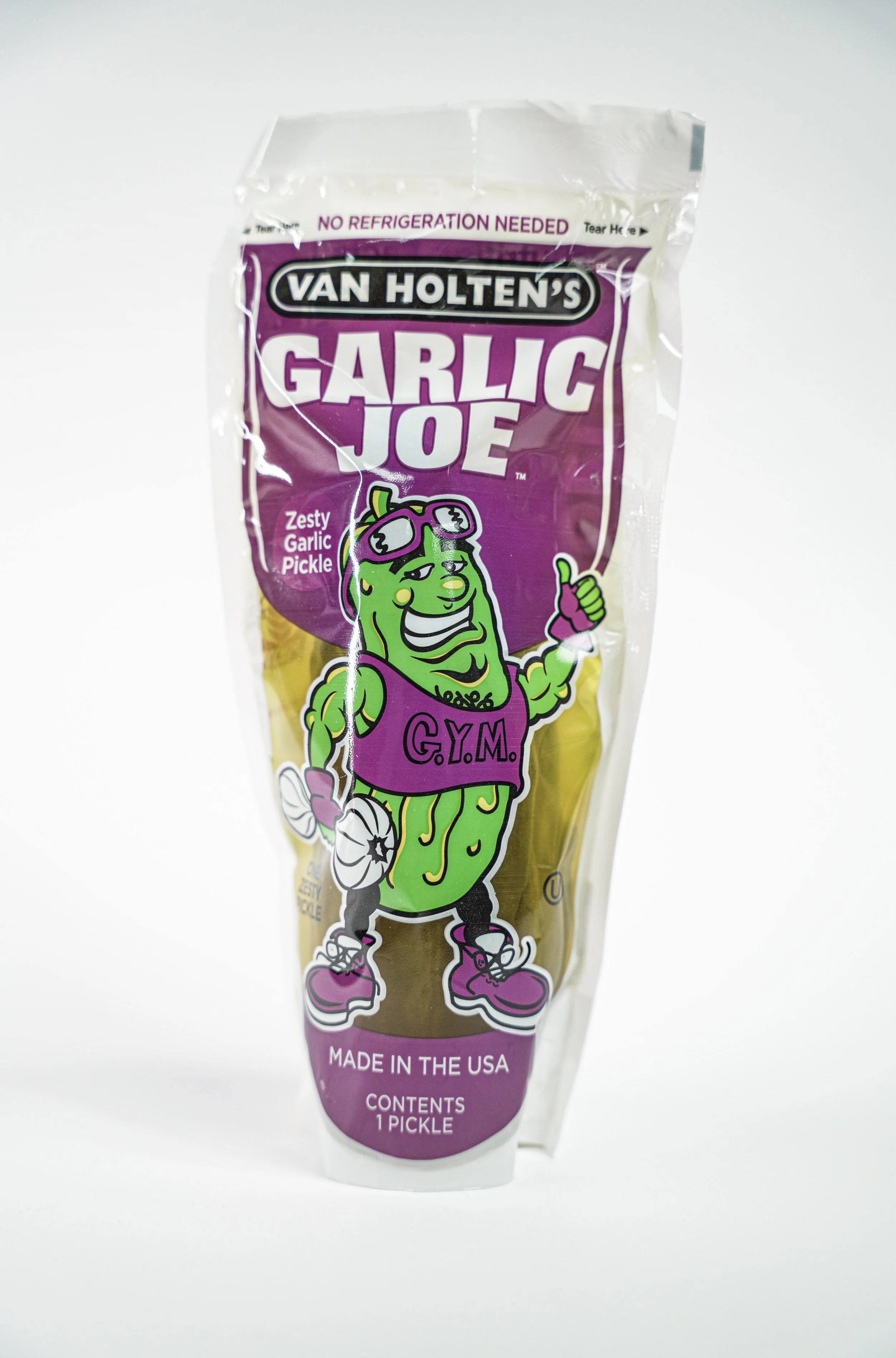 A package of Van Holten's Garlic Joe pickle with a cartoon pickle mascot wearing gym clothes and sunglasses, giving a thumbs up, with a white background.