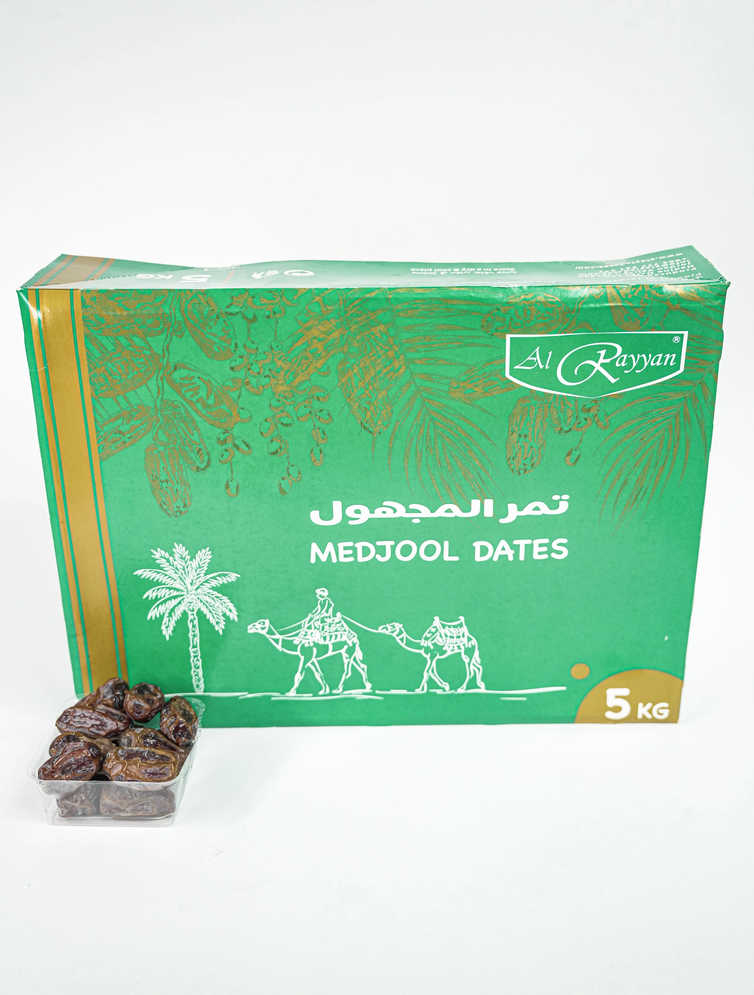Green box of Al Rayyan Medjool dates with a small plastic container of dates in front.