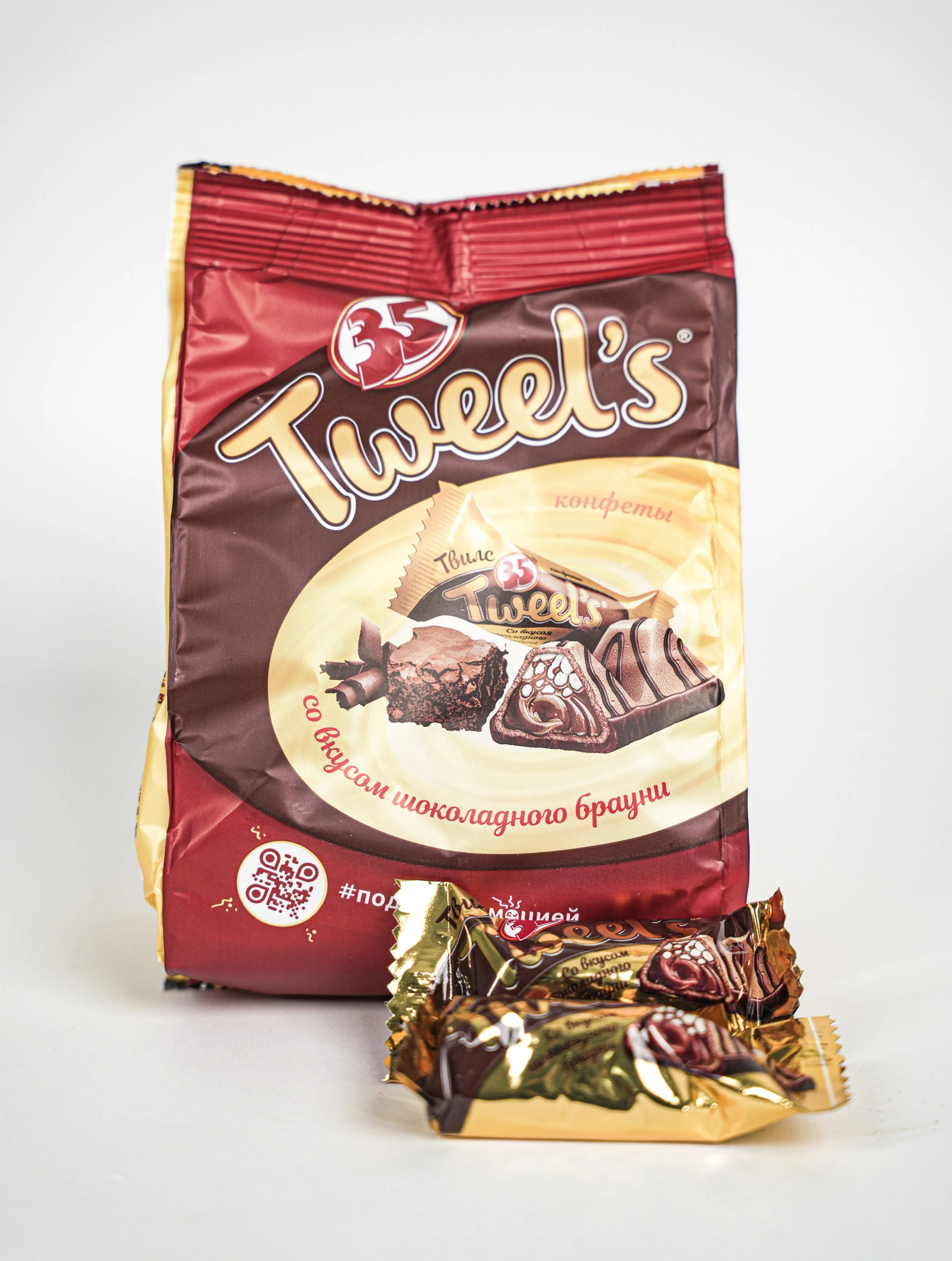 Bag of Russian chocolate candies called 'Twel's' with two individually wrapped candies in front.
