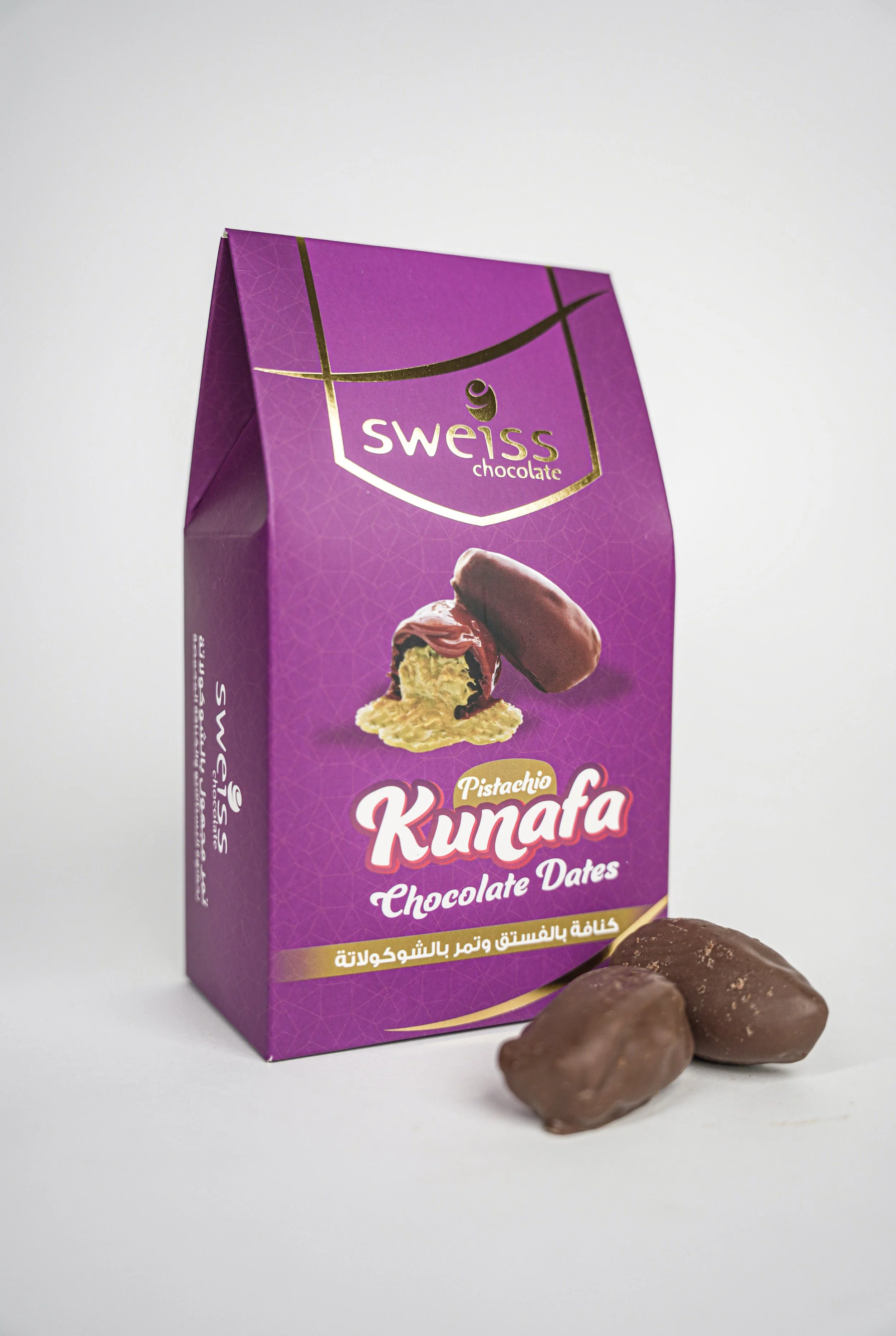 Sweiss Chocolate 'Kunafa' with pistachio flavor, featuring an image of a chocolate dates filled with pistachio and chocolate coating, with two chocolate dates in front of the box